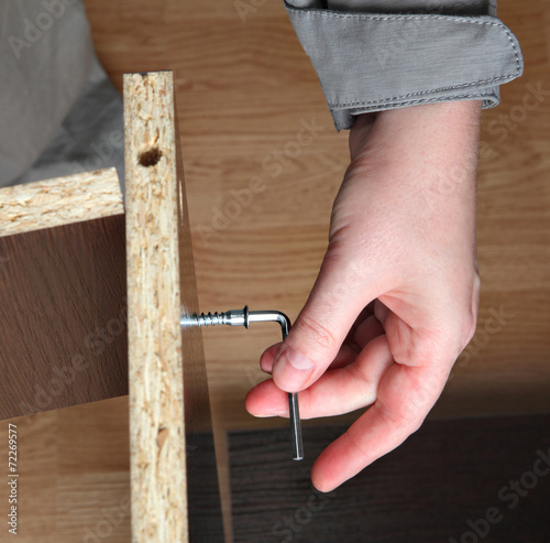 Furniture assembly, wood screw screwed  manually using allen ke photo