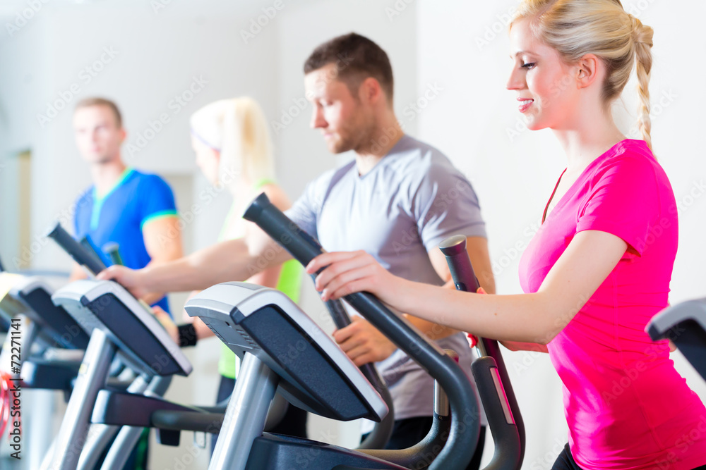 Men and women on treadmill in gym