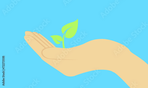 Young sprout in a hand on a blue background