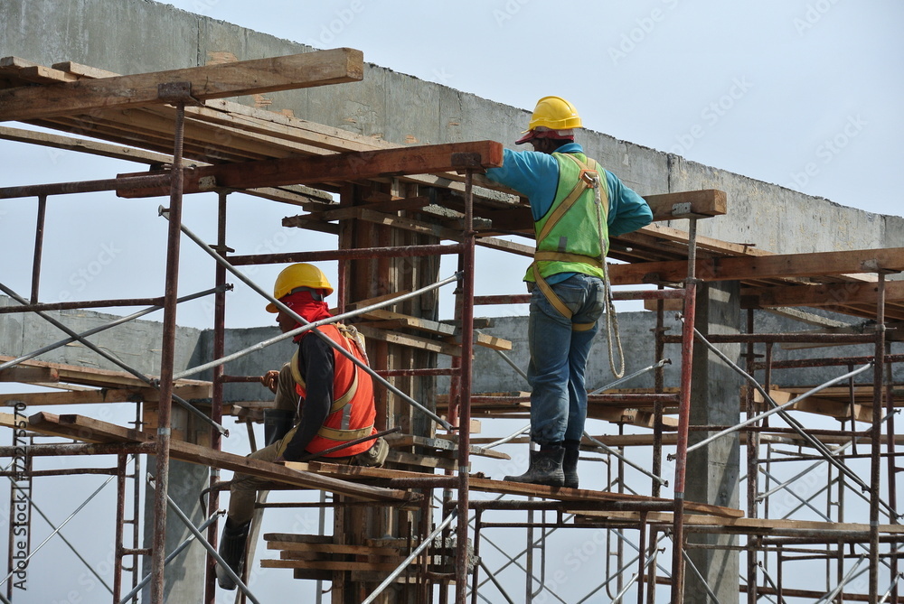 Construction workers dismantling beam formwork Stock Photo | Adobe Stock