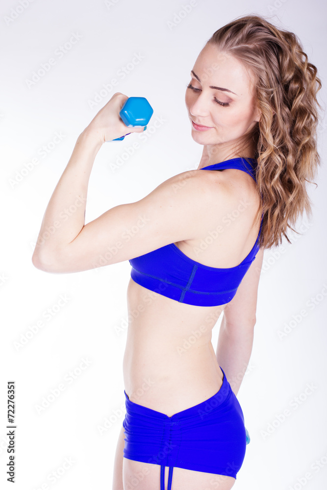 Young woman with blue dumbbells Young woman with blue dumbbells