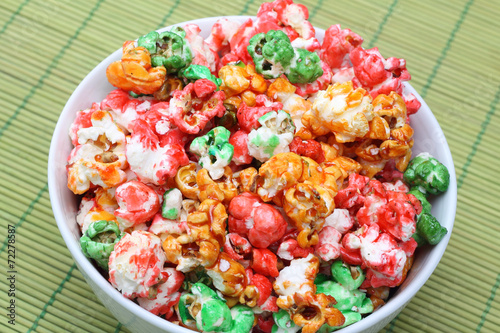 Colorful sugared popcorn in white bowl