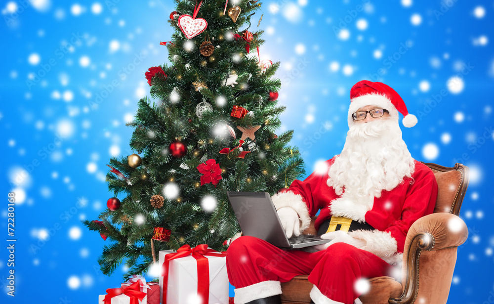 man in costume of santa claus with laptop man in costume of santa claus with laptop
