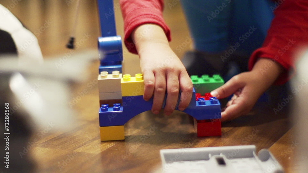 Child playing with blocks, closeup, steadycam shot, slow motion Child playing with blocks, closeup, steadycam shot, slow motion