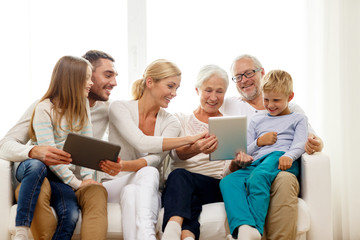 smiling family with tablet pc at home