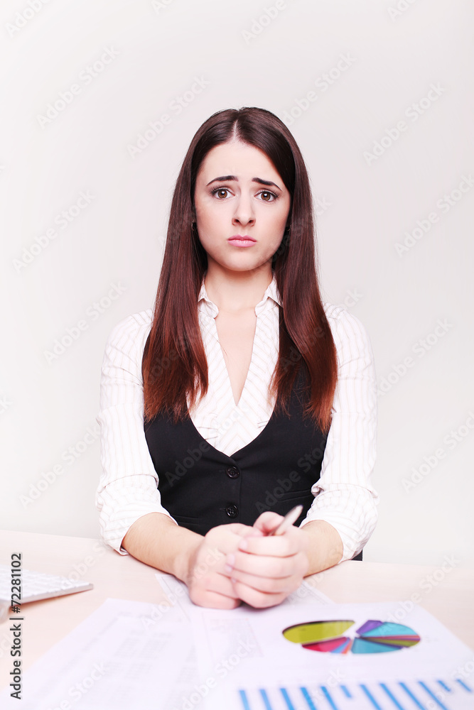 Portrait of a beautiful young business woman doing some paperwor Portrait of a beautiful young business woman doing some paperwor