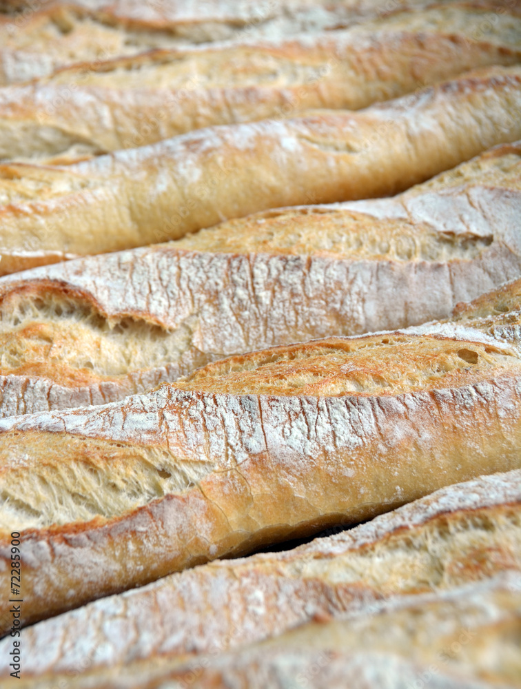 Row of Fresh Baked French Bread Sticks for Sale.