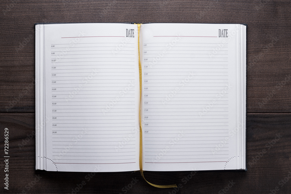 opened notebook on the wooden table opened notebook on the wooden table