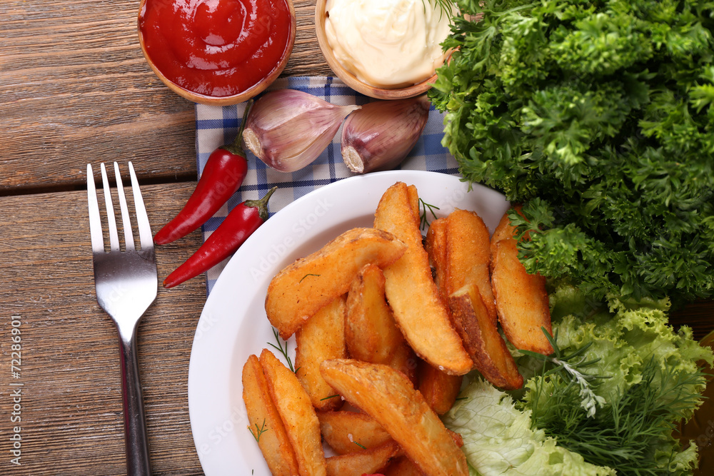 Homemade fried potato on plate on wooden background Homemade fried potato on plate on wooden background