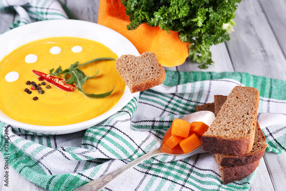 Pumpkin soup in white plate and pumpkin slice Pumpkin soup in white plate and pumpkin slice