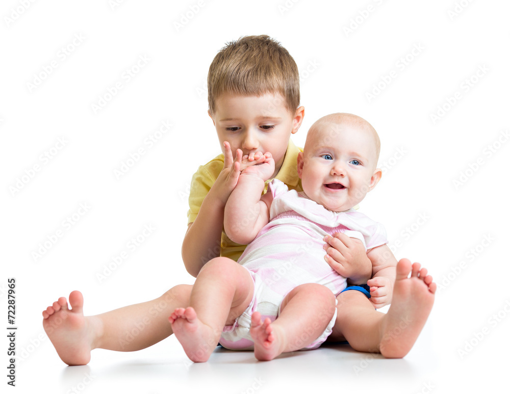 Kid boy and his sister baby girl isolated on white Kid boy and his sister baby girl isolated on white