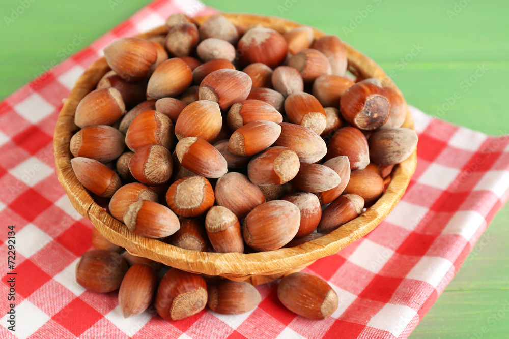 Hazelnuts on wicker mat on wooden background Hazelnuts on wicker mat on wooden background