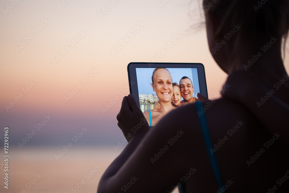 Family selfie with pad on the beach