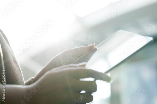 Woman using tablet PC against bright sunlight