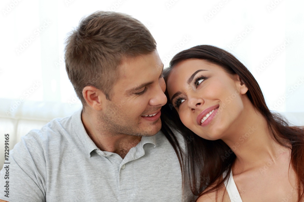Smiling couple sitting on the sofa together