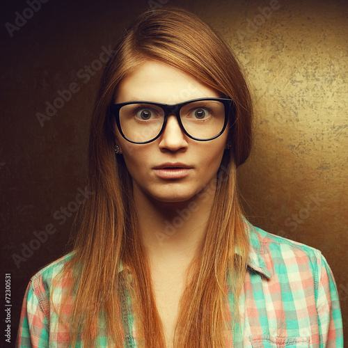 Portrait of gorgeous red-haired girl in glasses