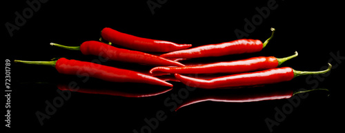 Perspective view of red peppers isolated black background