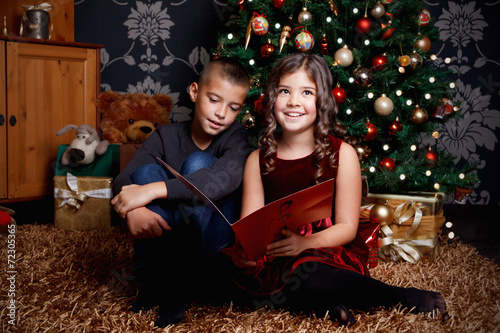 Cute children singing a song at Christmas Eve