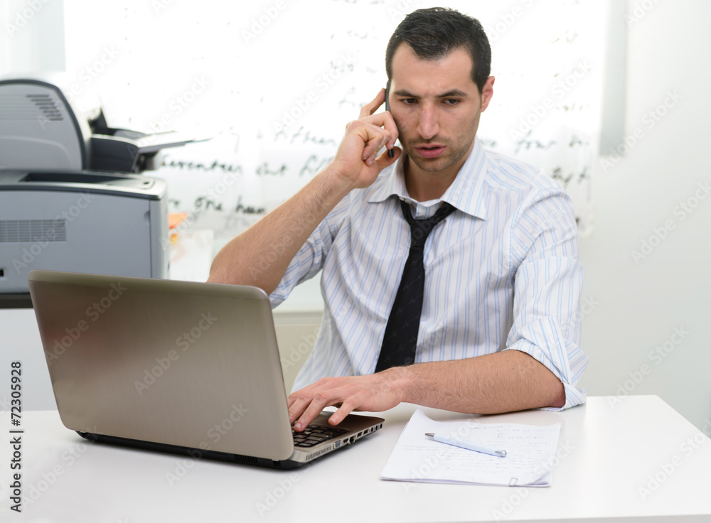 Businessman with laptop talking on the phone Businessman with laptop talking on the phone