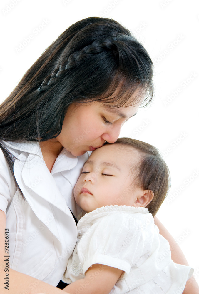 mother carrying and kissing her sleeping baby mother carrying and kissing her sleeping baby