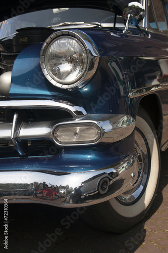 Front of a vintage blue oldtimer with chrome parts photo