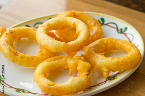 onion rings and dip sauce on the plate