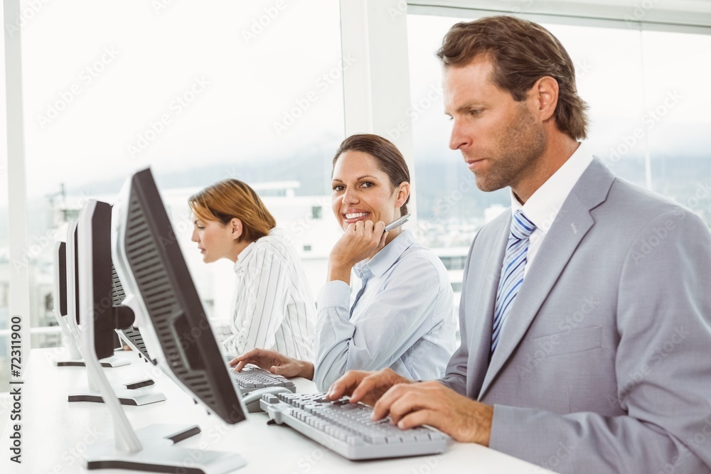 Business people using computers in office Business people using computers in office