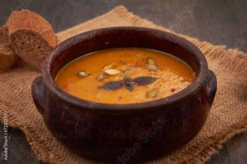 Bowl of pumpkin soup with bread