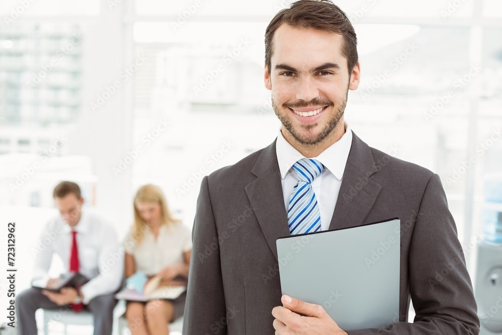 Businessman against people waiting for interview Businessman against people waiting for interview