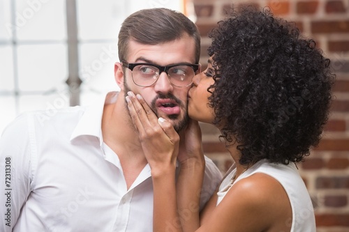 Woman kissing man in office