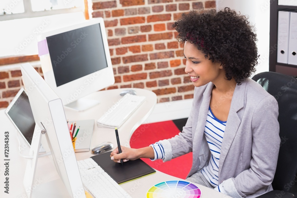 Female photo editor using digitizer in office Female photo editor using digitizer in office