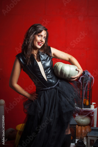 Gothic girl image holding  pumpkin and smiling © zadveri