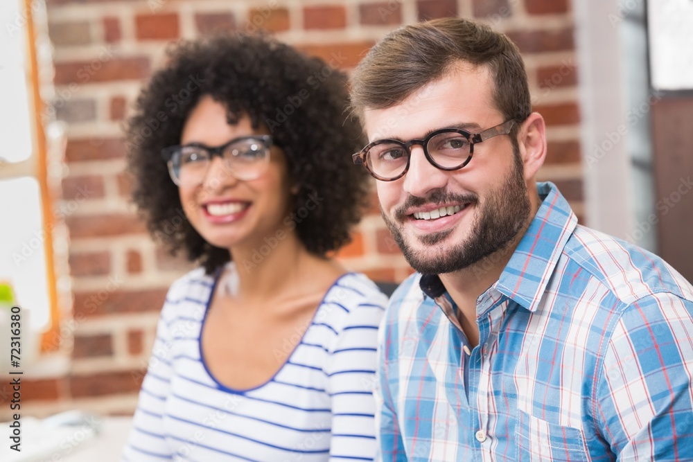 Young business people smiling in office Young business people smiling in office
