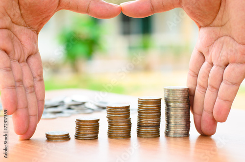 Male hand protect money coins stack photo