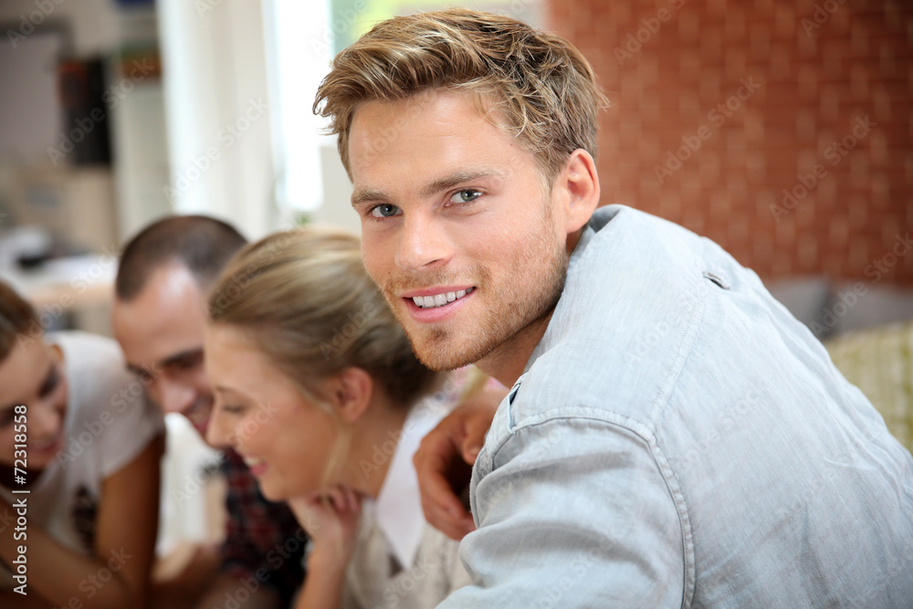 Portrait of handsome guy amongst group of friends Portrait of handsome guy amongst group of friends