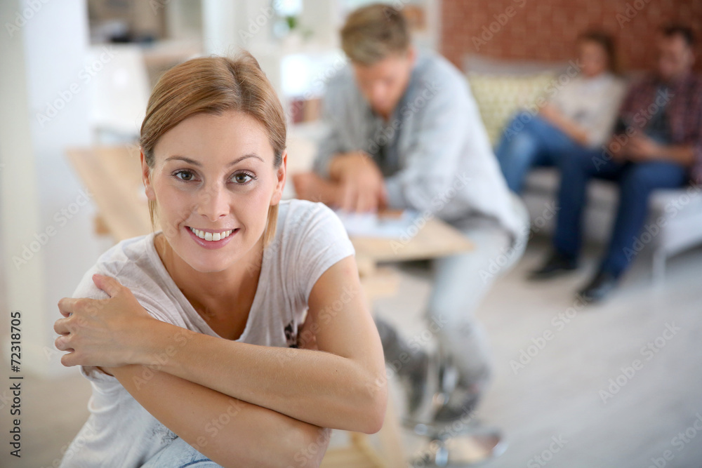 Smiling woman sitting in shared apartment