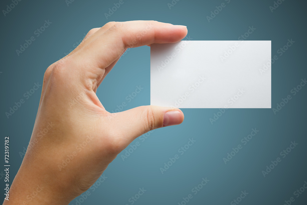 hand holding a white business card on a blue background hand holding a white business card on a blue background