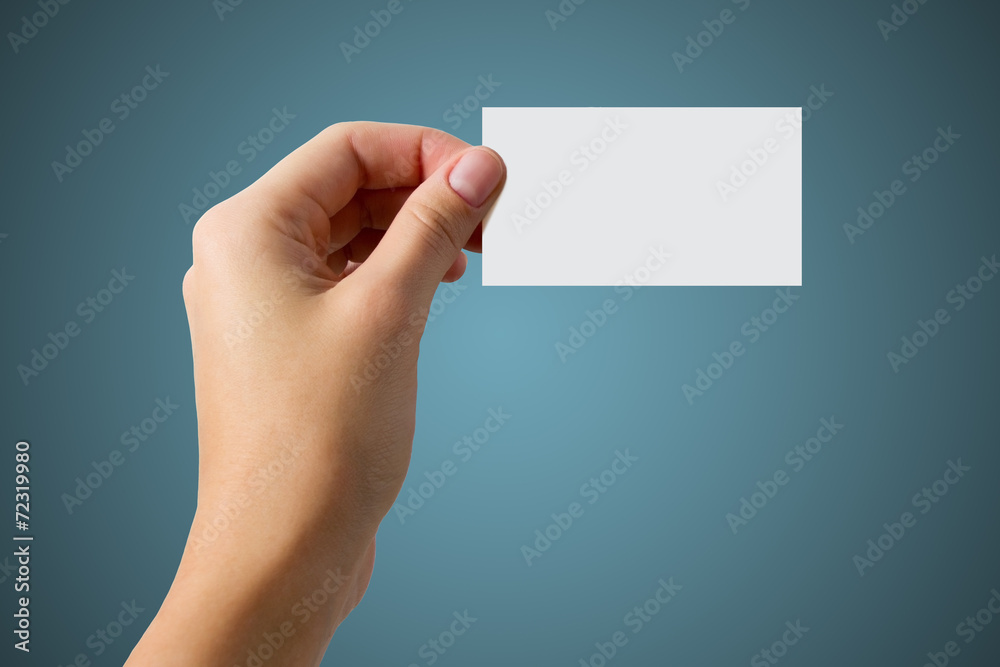 hand holding a business card on a blue background hand holding a business card on a blue background