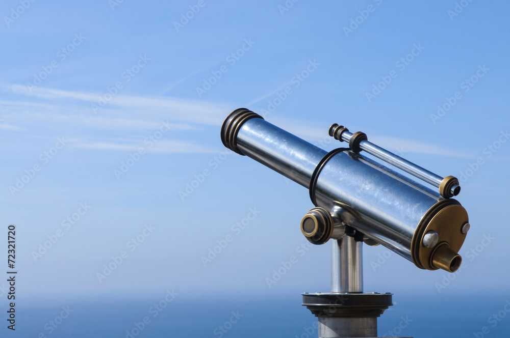 Touristic Metal Spyglass on the sky background Touristic Metal Spyglass on the sky background