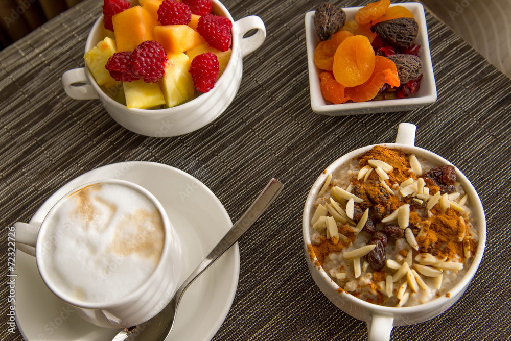 Fresh fruit and oatmeal with healthy toppings for breakfast Fresh fruit and oatmeal with healthy toppings for breakfast