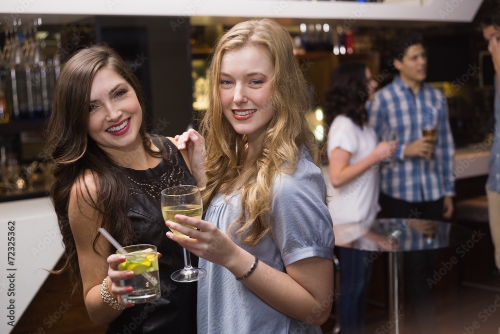 Pretty friends having a drink together