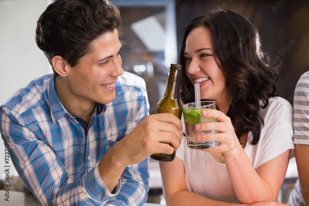 Happy friends having a drink together Happy friends having a drink together