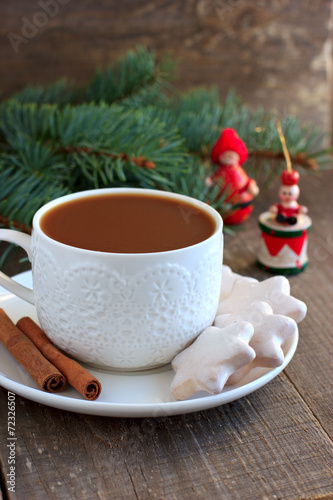 Tea with milk and cinnamon and Christmas decor