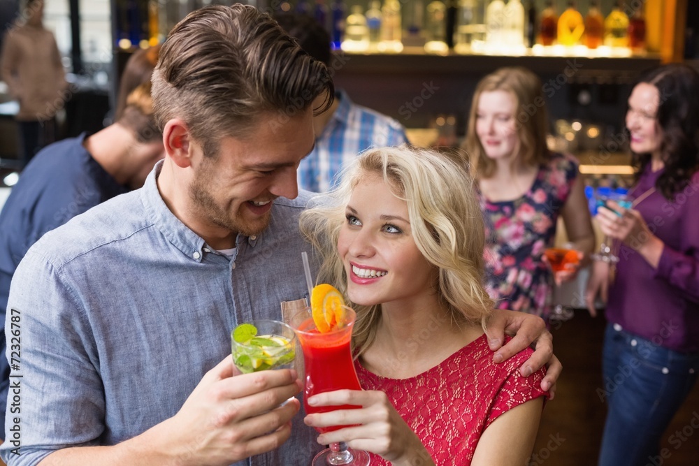 Happy couple drinking cocktails together Happy couple drinking cocktails together
