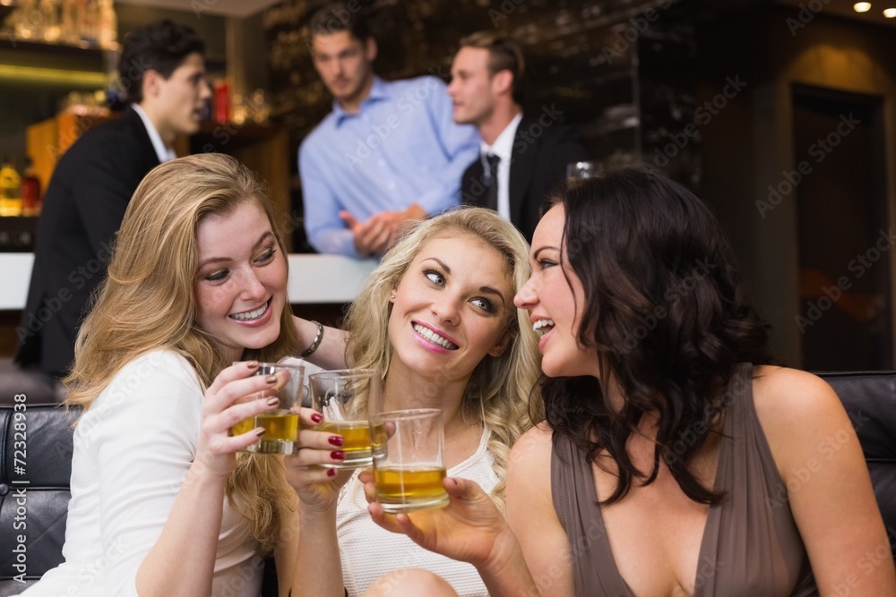 Pretty friends having a drink together