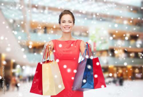 smiling woman with colorful shopping bags