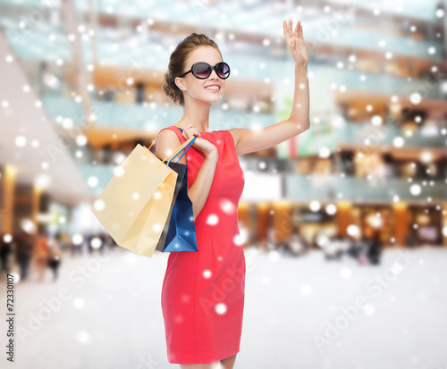 smiling woman with colorful shopping bags