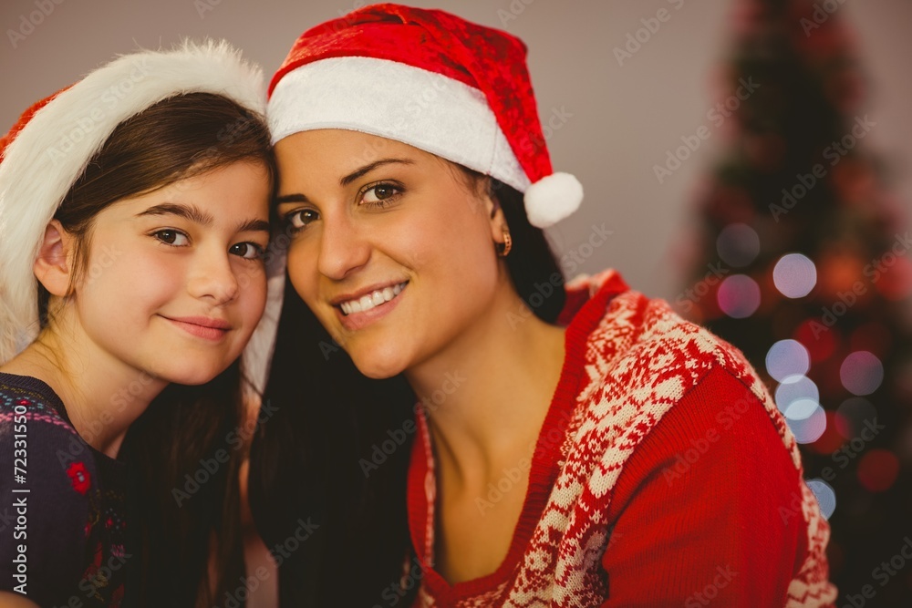 Festive mother and daughter smiling at camera Festive mother and daughter smiling at camera