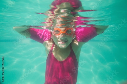 Fototapeta Naklejka Na Ścianę i Meble -  Cute kid posing underwater in pool