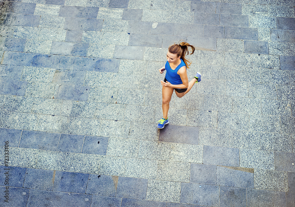 Young woman running in city center Young woman running in city center